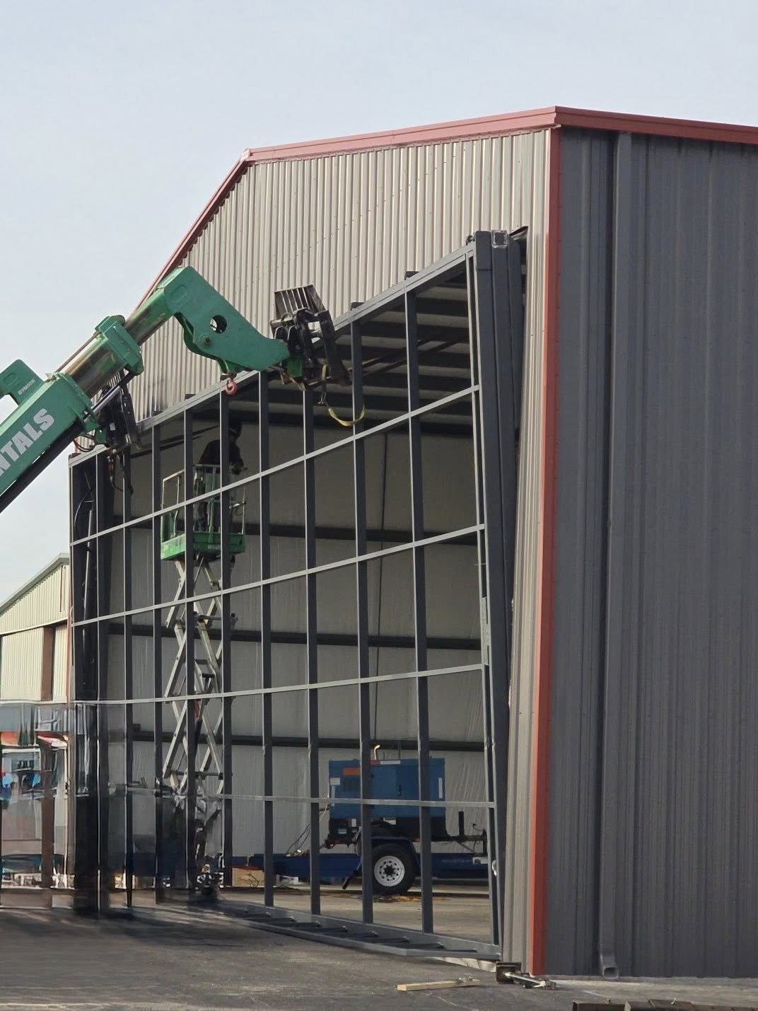 Aircraft hangar under construction with sidewall sheeting being installed